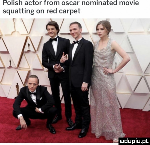 polish aktor from oscar nominated mobie squatting on red carpet